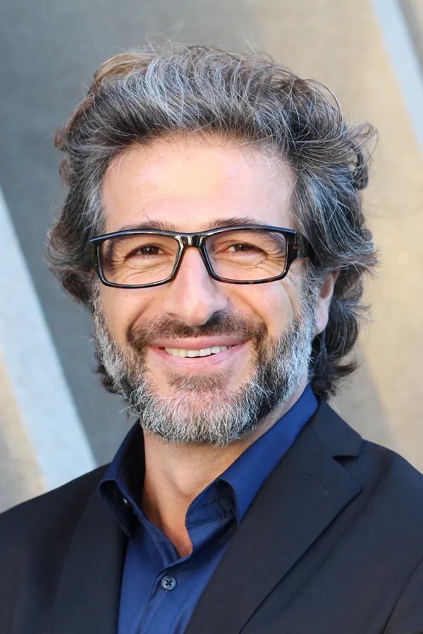 Andropause-and-Low-Testosterone-Treatment A man with glasses, salt and pepper hair and a beard smiling because he received treatment for andropause and low testosterone from Proactive Wellness Centers in Loudoun County.