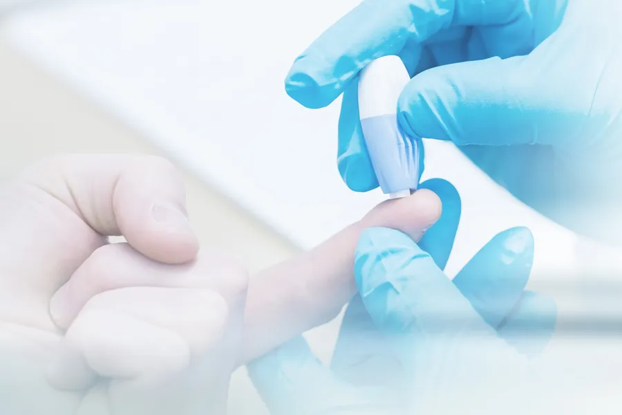 Diabetes-Doctor A doctor's gloved hand pricks a patients finger with to measure blood sugar, symbolizing diabetes treatment from Proactive Wellness Centers in Loudoun County.