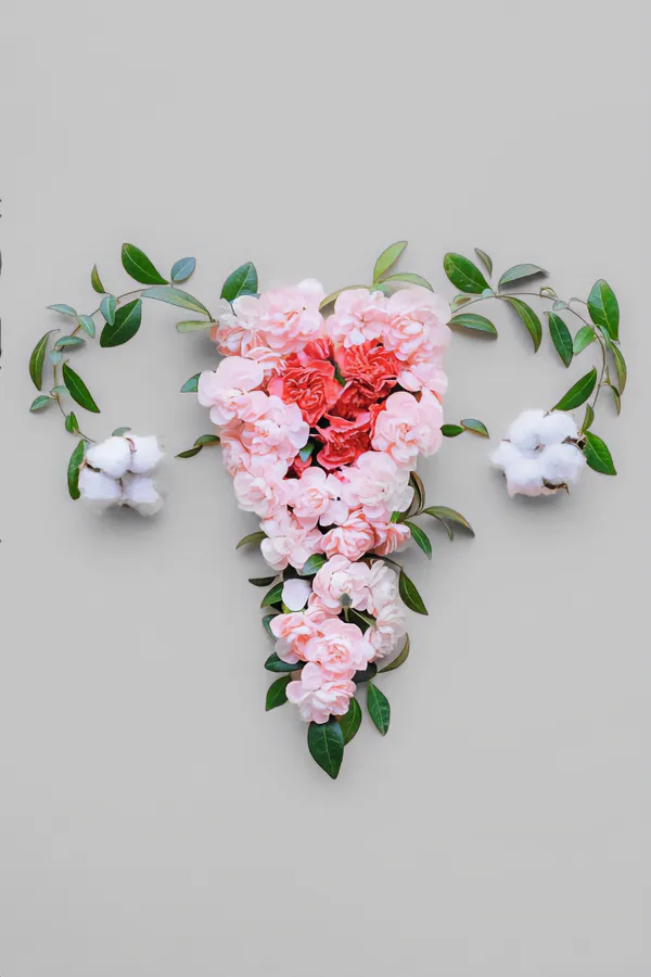 Endometriosis-Treatment Flowers on a gray background, arranged in the shape of the female reproductive system, representing Endometriosis treatment from Proactive Wellness Centers in Loudoun County.