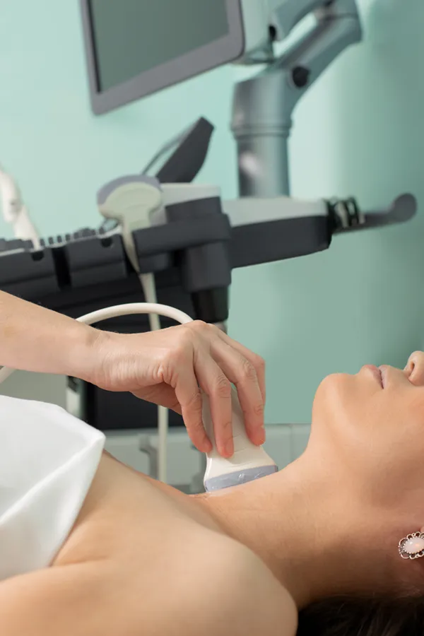 Hashimotos-Thyroiditis-Treatment A woman gets a thyroid scan from a doctor in a clinic. Get help with Hashimoto's Thyroiditis from Proactive Wellness Centers in Loudoun County.