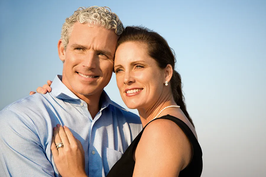 Healthy-Aging-Peptides-Doctor A middle-aged caucasian couple embraces in the sunshine, happy with the healthy aging peptide treatments from Proactive Wellness Centers in Loudoun County