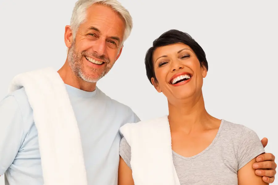 PEMF-Therapy-Clinic A mature man and woman with towels draped over their shoulders smiling after a work out. Get PEMF Pulsed Electromagnetic Field therapy from Proactive Wellness Centers in Loudoun County.