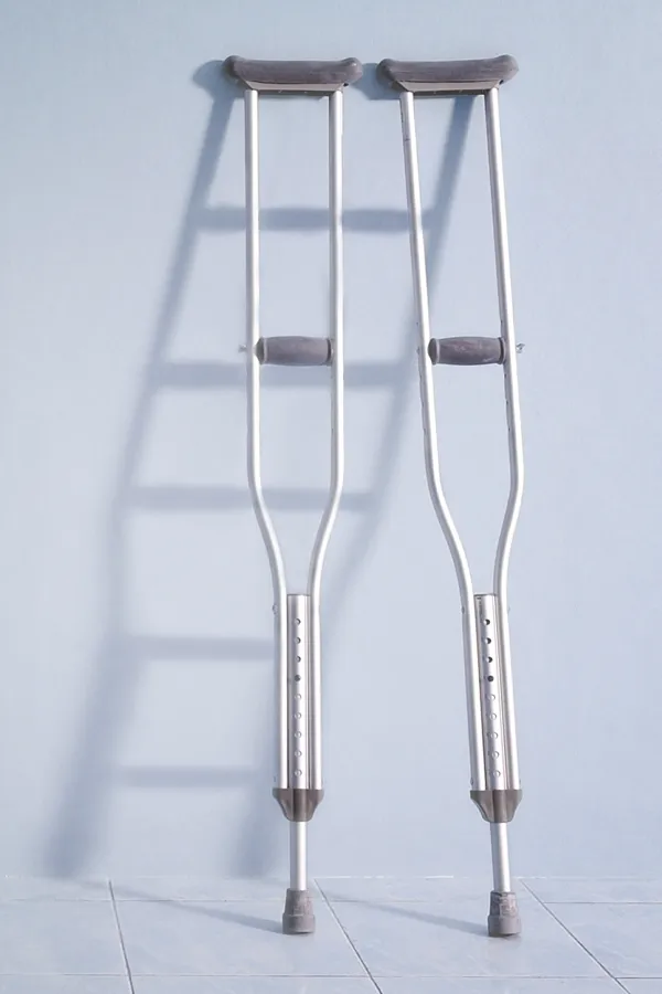 Peptides-for-Healing-and-Recovery-Treatment A pair of crutches rest against a gray wall, representing peptide therapy for healing and recovery from Proactive Wellness Centers in Loudoun County.