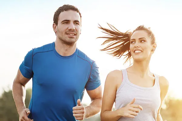 Weight-Loss-Resistance-Doctor A couple happily jogging in the sunlight after receiving effective weight loss resistance care from Proactive Wellness Centers in Loudoun County.